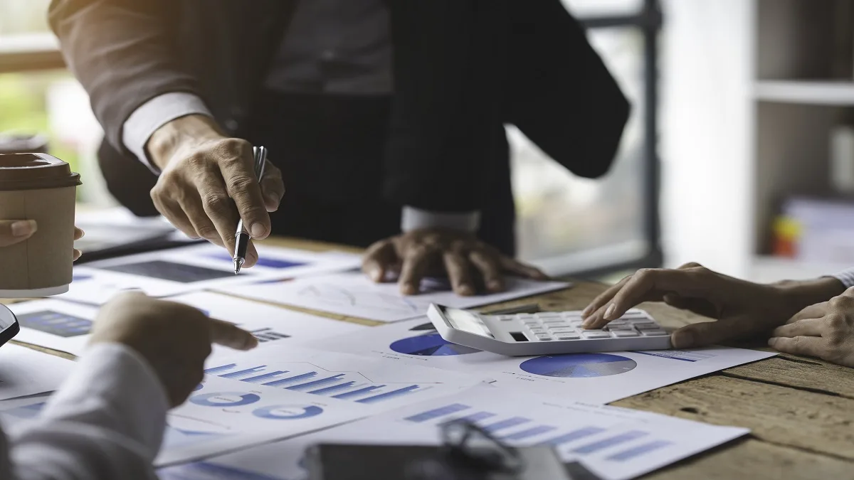 Business owner reviewing tax compliance documents and payroll records